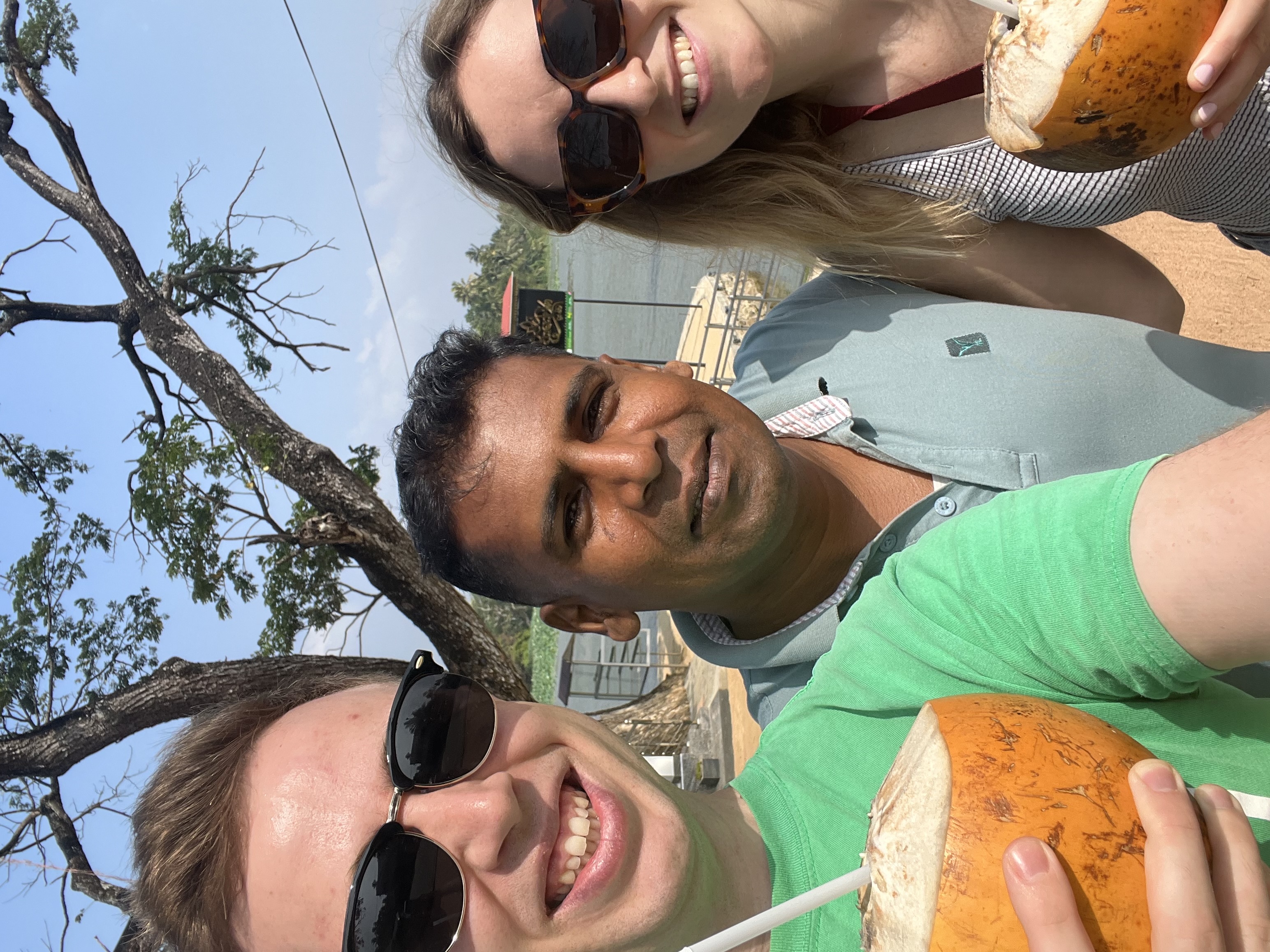 Tourists relaxing under traditional thatched hut – authentic cultural experience Sri Lanka